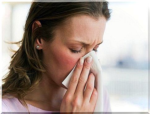 woman with handkerchief to her nose