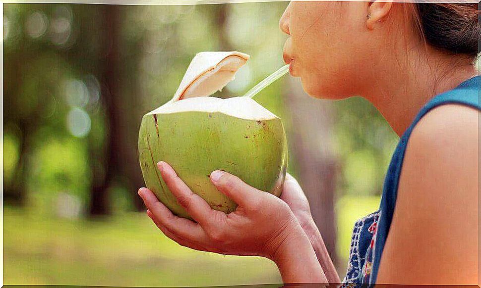 Woman drinks from coconut