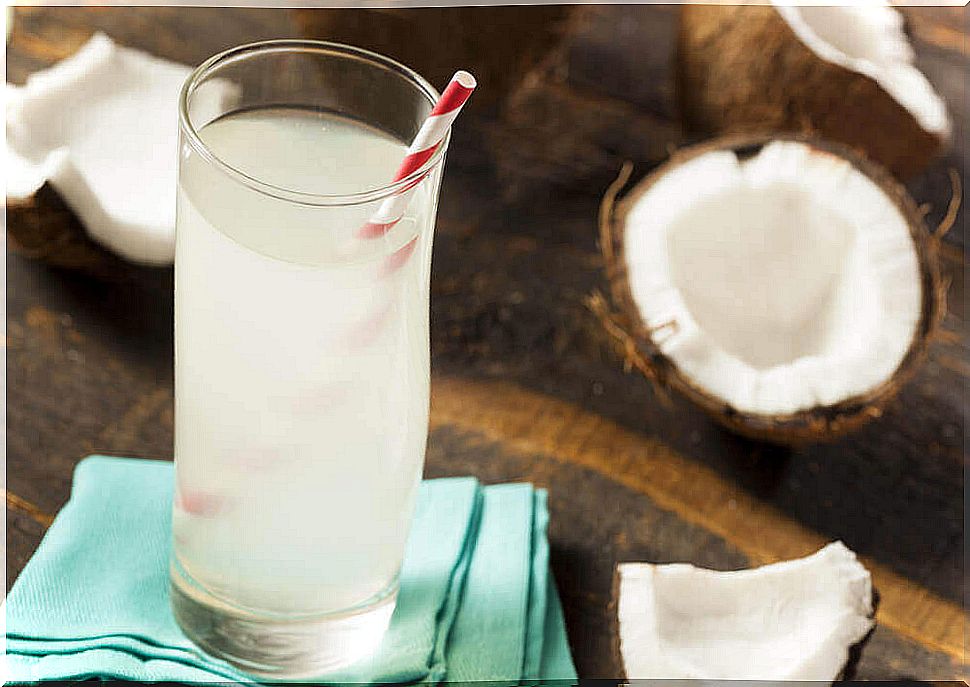 Glass of coconut water with a straw