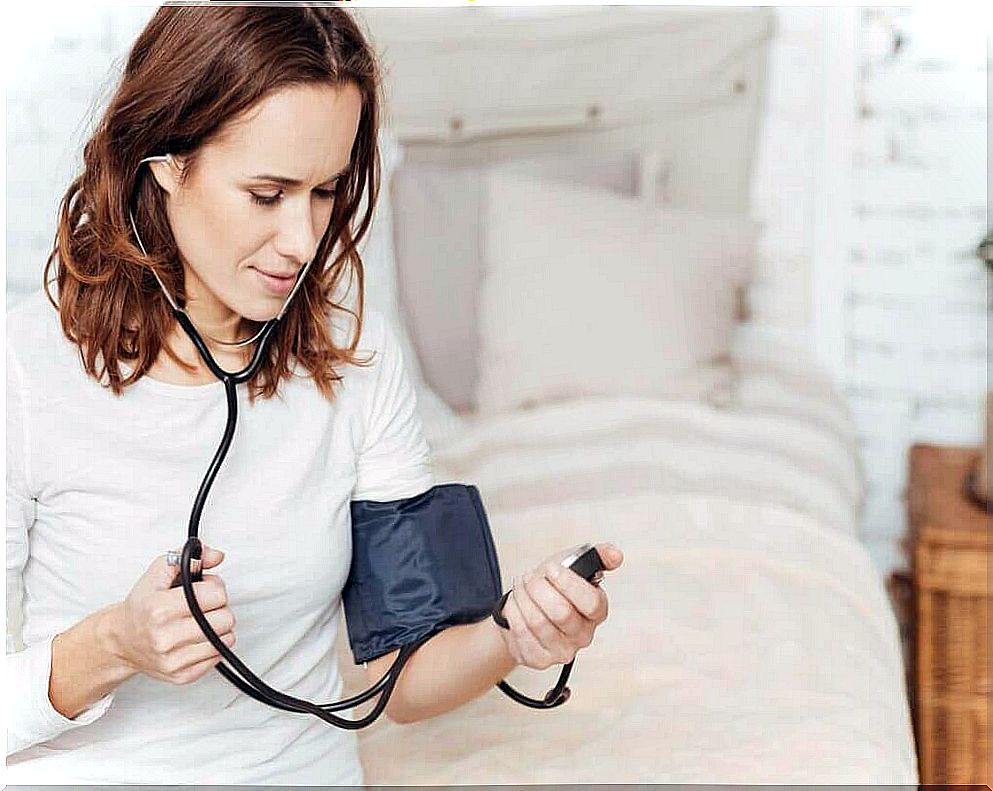 Woman measures blood pressure