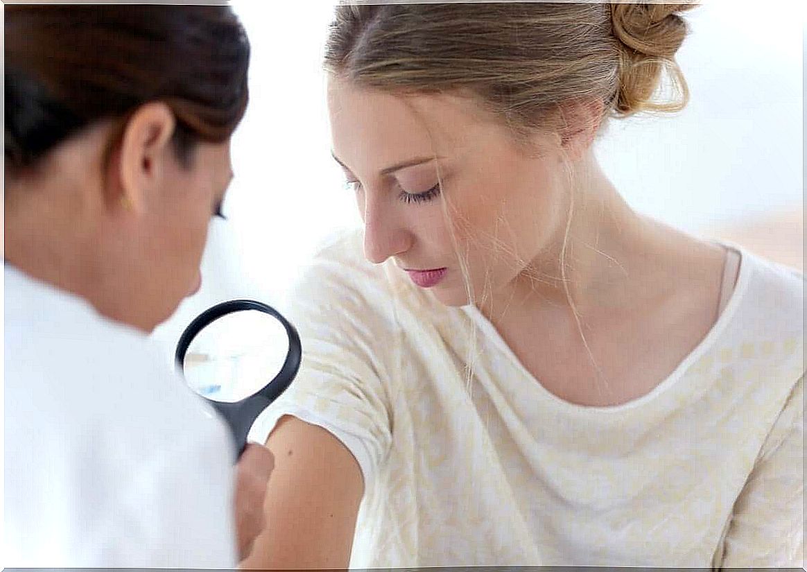 Dermatologist examines skin