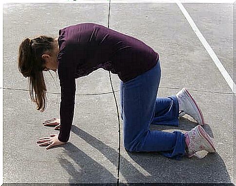 A woman doing the cat stretching exercise