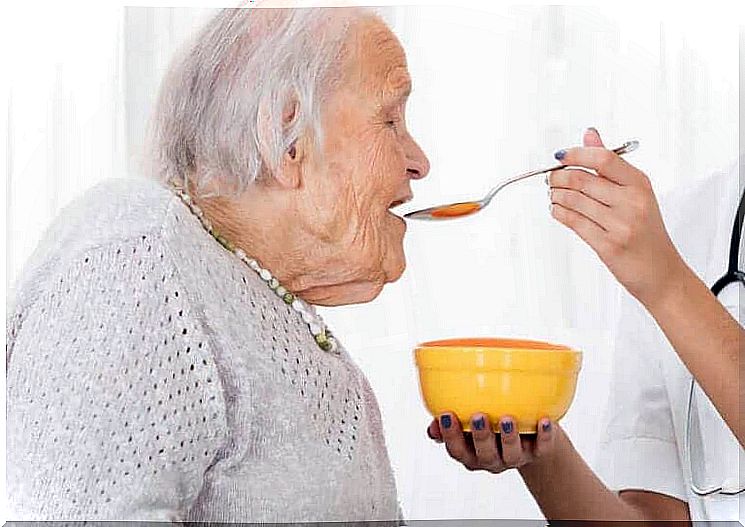 Elderly woman eats liquid food