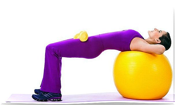 Stretching hamstrings with a fitness ball