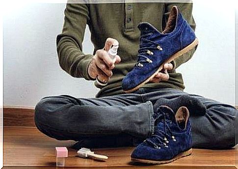 man uses spray on suede shoes