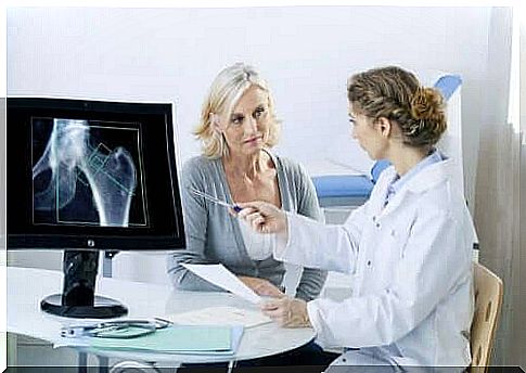 A woman is sitting at a doctor's desk