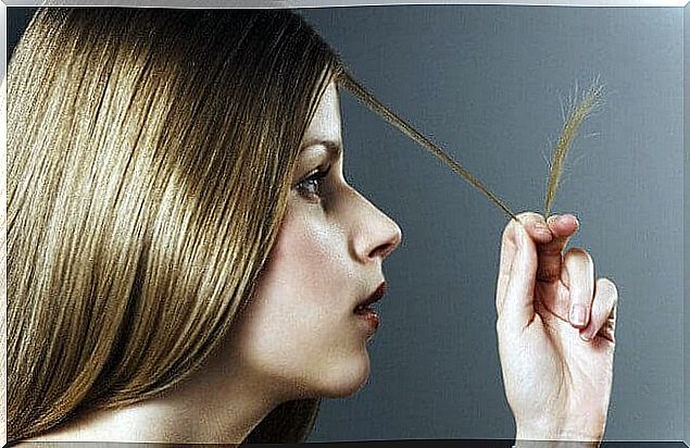 Girl looking at her split ends