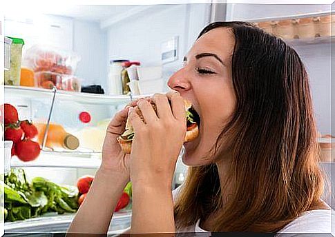 Woman eats big sandwich