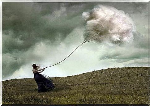 Woman being swept away by a dark cloud