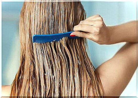 A woman combs her hair