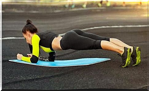 Woman does the plank in the street