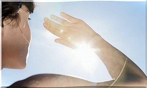 hand tries to block sunlight