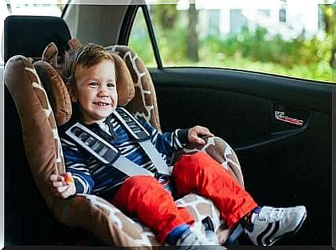 Happy child in a car seat